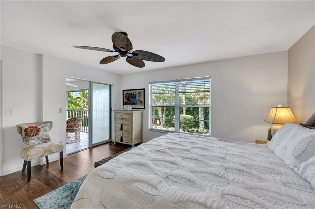 509 Roma Court, Unit 202 Naples, FL 34110 - Photo 10 of 18 Bedroom featuring dark wood-style floors, access to outside, and a ceiling fan