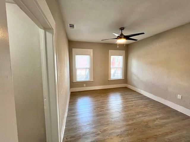 425 Grandview Avenue Dallas, TX 75223 - Photo 12 of 25 a view of empty room with wooden floor and fan
