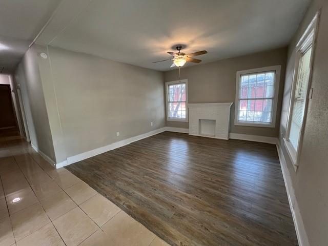 425 Grandview Avenue Dallas, TX 75223 - Photo 6 of 25 an empty room with wooden floor and windows