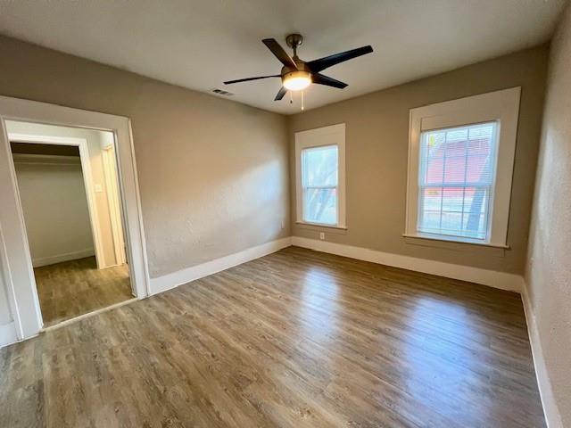 425 Grandview Avenue Dallas, TX 75223 - Photo 7 of 25 a view of a livingroom with wooden floor and a ceiling fan