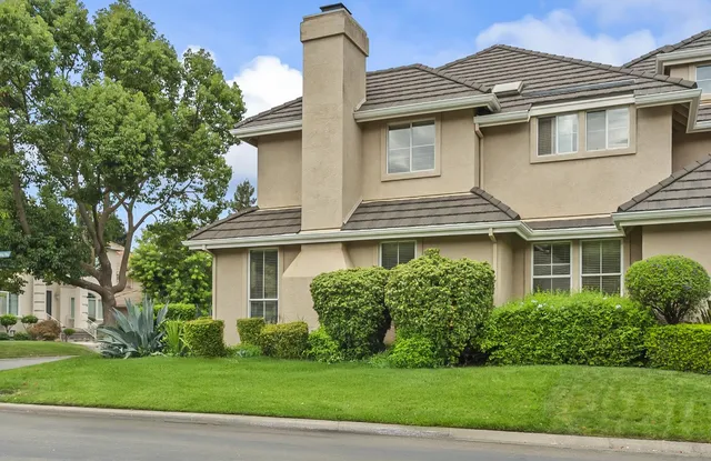 a view of a livingroom with furniture wooden floor and a chandelier