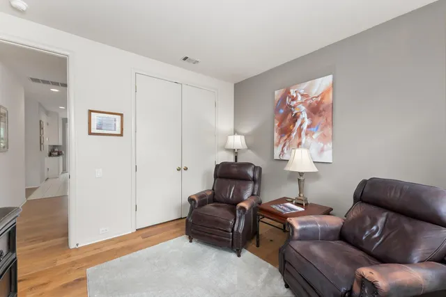 an aerial view of ocean and residential houses with outdoor space