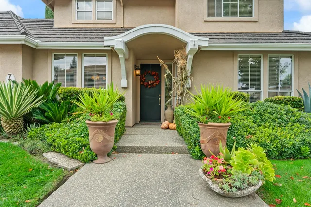 a front view of a house with garden