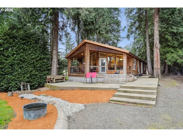 a view of a house with swimming pool and sitting area