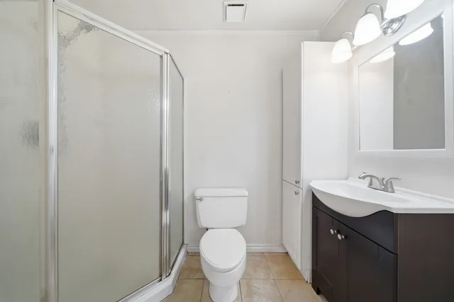 a bathroom with a toilet a sink a mirror a vanity and vanity