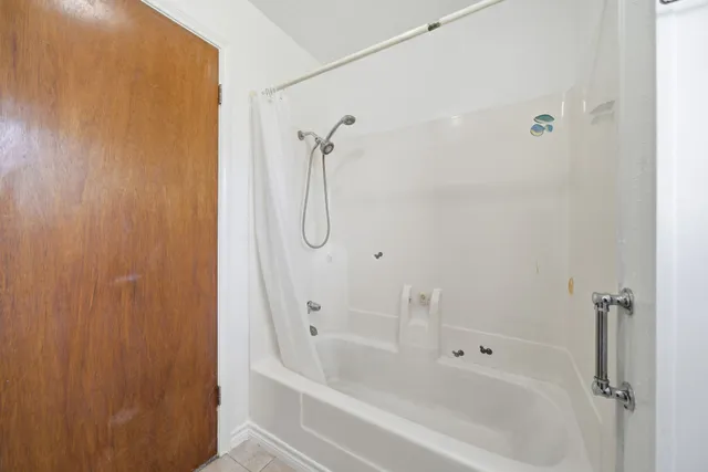 a bathroom with a shower and a bathtub