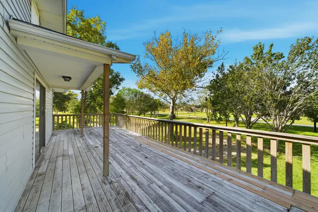 a view of a balcony with wooden floor