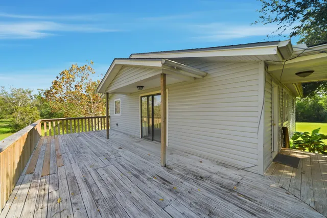 a view of a house with a wooden deck