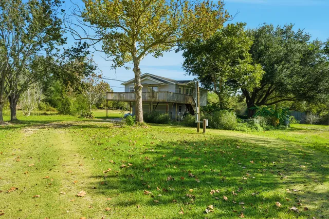 a house with huge green field in front of it