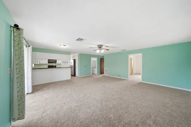 a view of a kitchen with an empty space and a sink