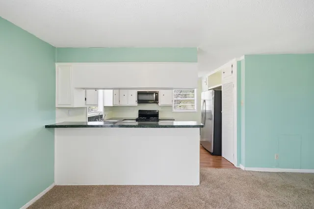 a kitchen with stainless steel appliances a sink and a refrigerator