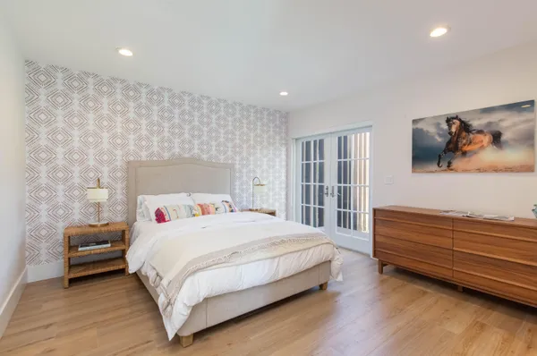 a bedroom with a bed and a flat screen tv