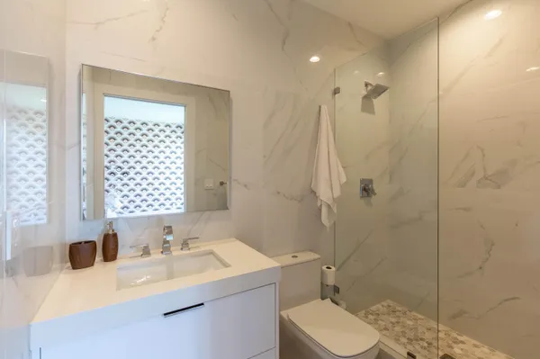 a bathroom with a sink toilet and shower
