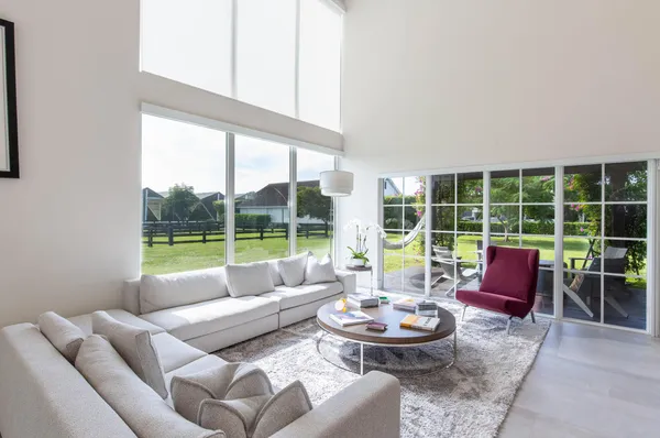a living room with furniture and a large window