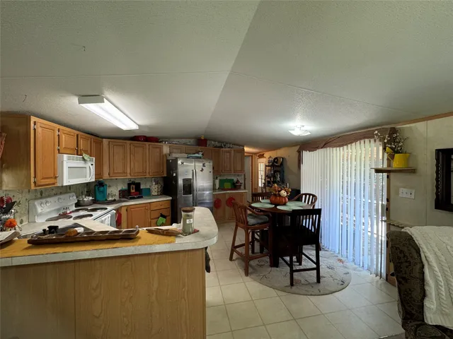 a view of a hallway with workspace and a window