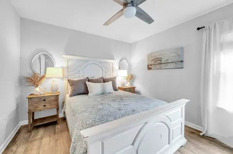a bedroom with a bed and a chandelier
