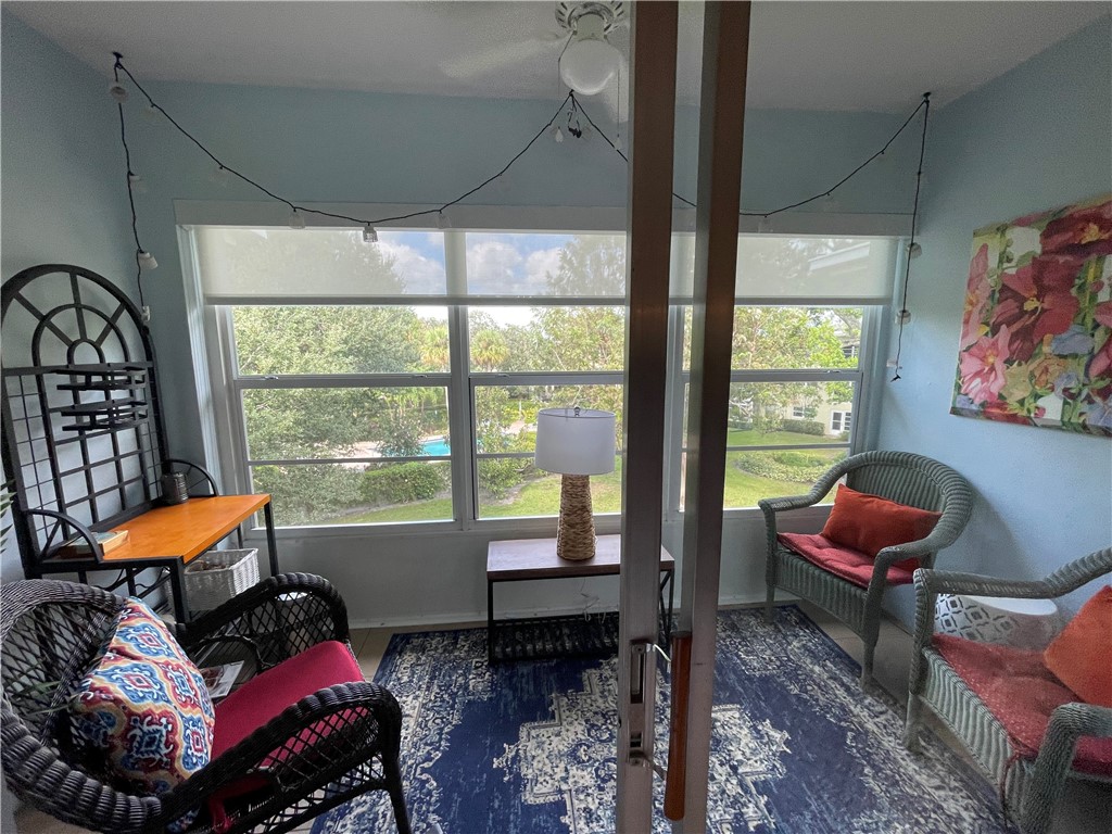 1100 Ponce De Leon Circle, Unit E306 Vero Beach, FL 32960 - Photo 11 of 30 a living room with furniture and a floor to ceiling window