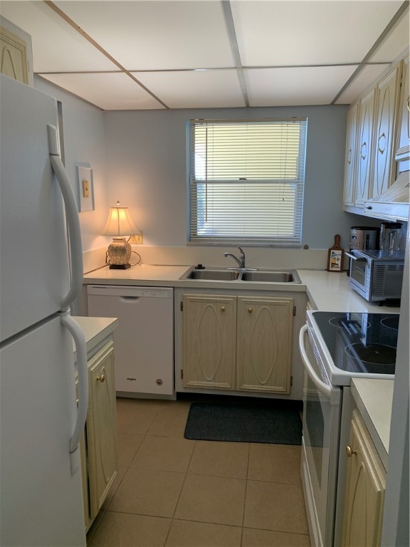 1100 Ponce De Leon Circle, Unit E306 Vero Beach, FL 32960 - Photo 16 of 30 a kitchen with a sink a stove a refrigerator and cabinets