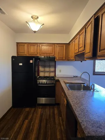 a kitchen with a sink appliances and cabinets