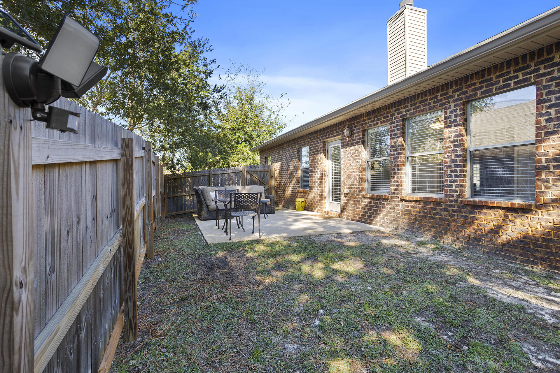 137 Old Ferry Road Santa Rosa Beach, FL 32459 - Photo 15 of 38 a backyard of a house with table and chairs