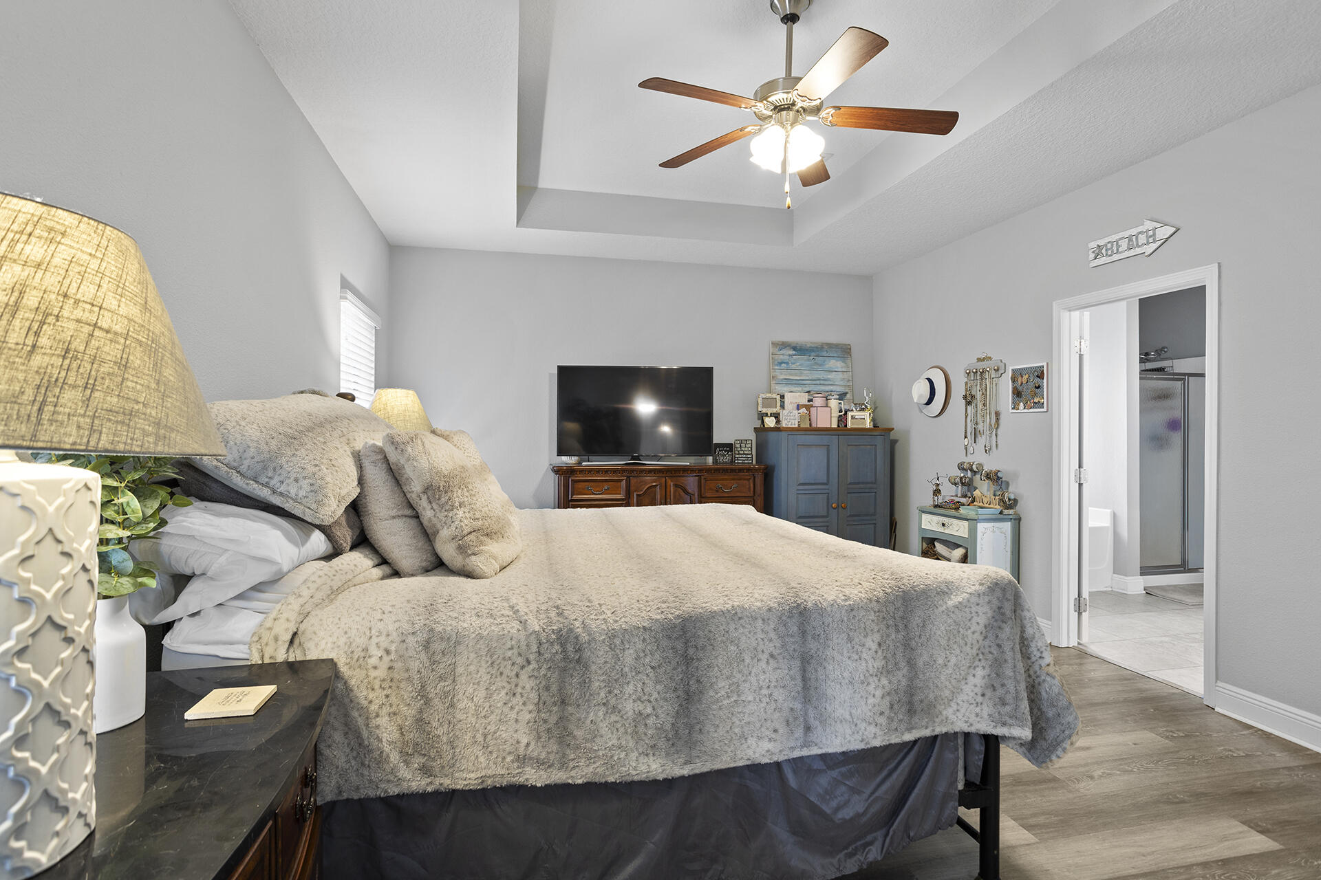 137 Old Ferry Road Santa Rosa Beach, FL 32459 - Photo 19 of 38 a bedroom with a bed and a chandelier