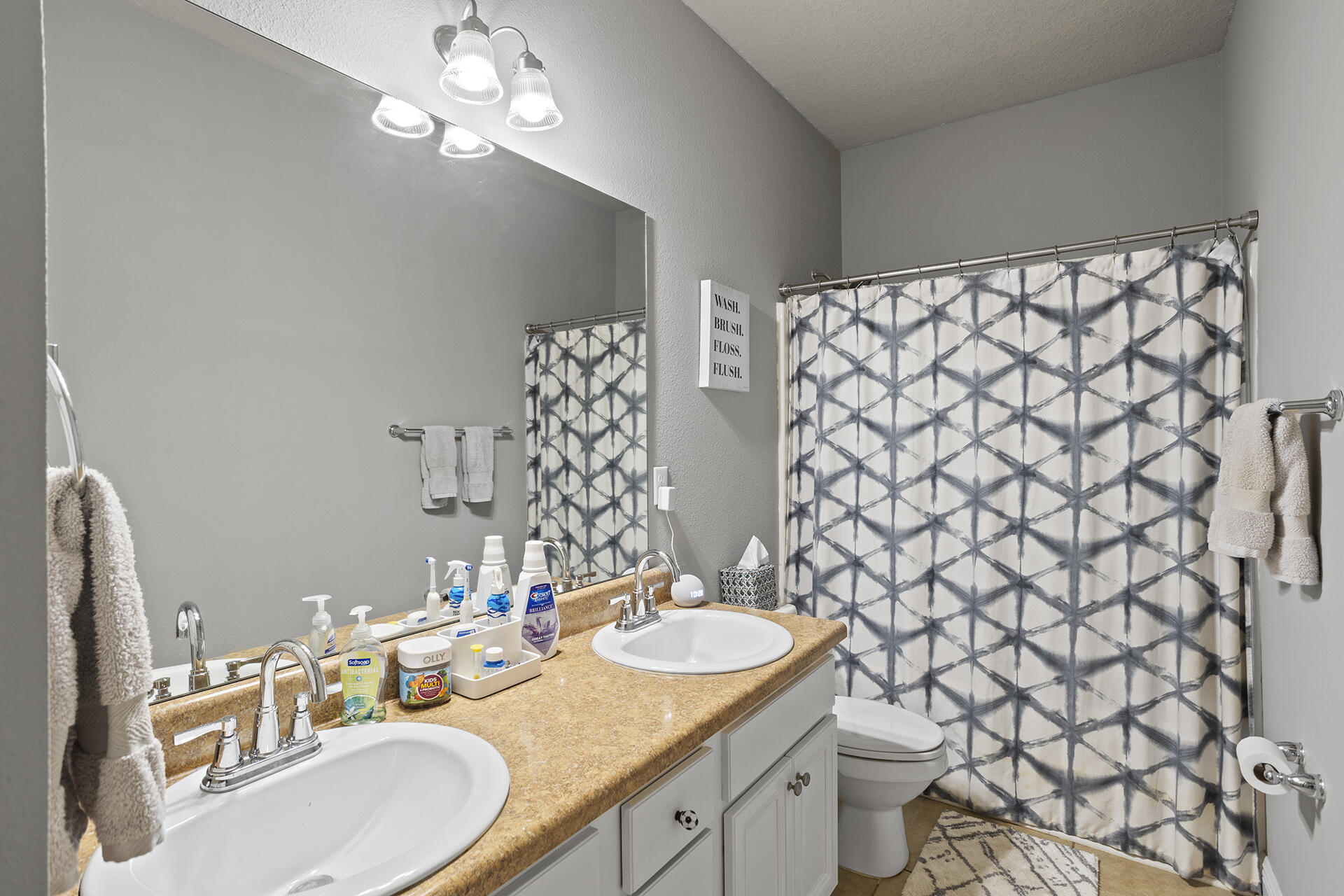 137 Old Ferry Road Santa Rosa Beach, FL 32459 - Photo 22 of 38 a bathroom with a granite countertop sink and a mirror with toilet