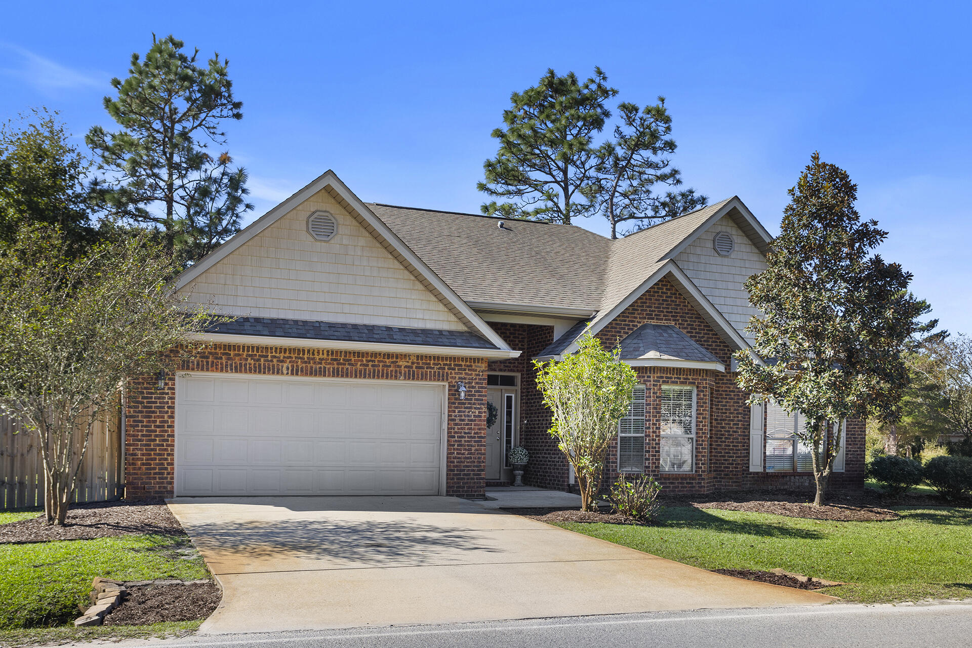 137 Old Ferry Road Santa Rosa Beach, FL 32459 - Photo 5 of 38 a front view of a house with a garden and trees