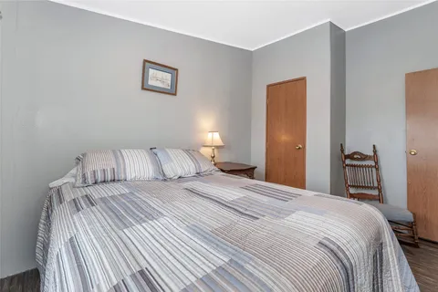 a bedroom with a bed and a lamp