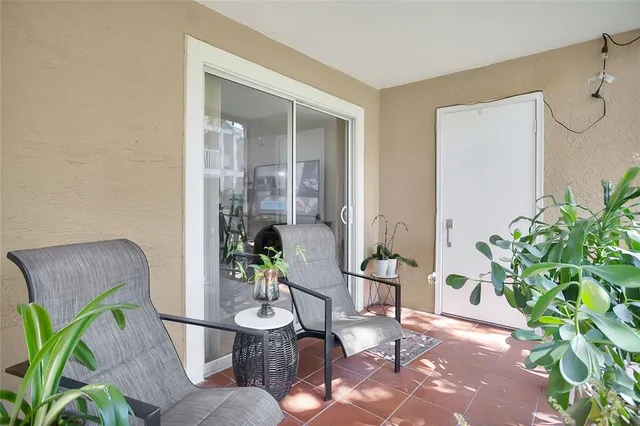a living room with furniture flowerpot and wooden floor