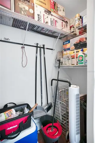 a utility room with closet and wooden floor