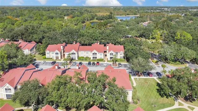 an aerial view of residential houses with outdoor space and trees