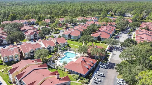 an aerial view of a houses with a lake view