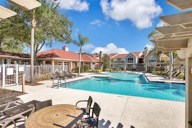 swimming pool view with a seating space and a garden view