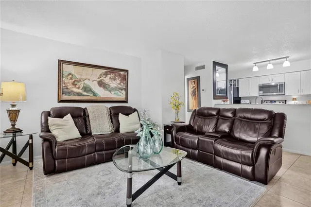 a living room with furniture and a painting