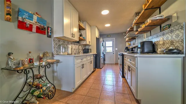 a kitchen with stainless steel appliances a sink and cabinets