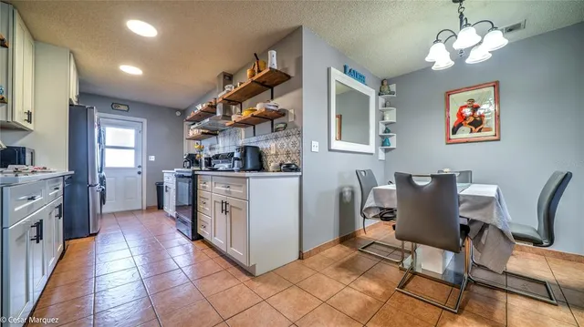 a kitchen with cabinets and chairs