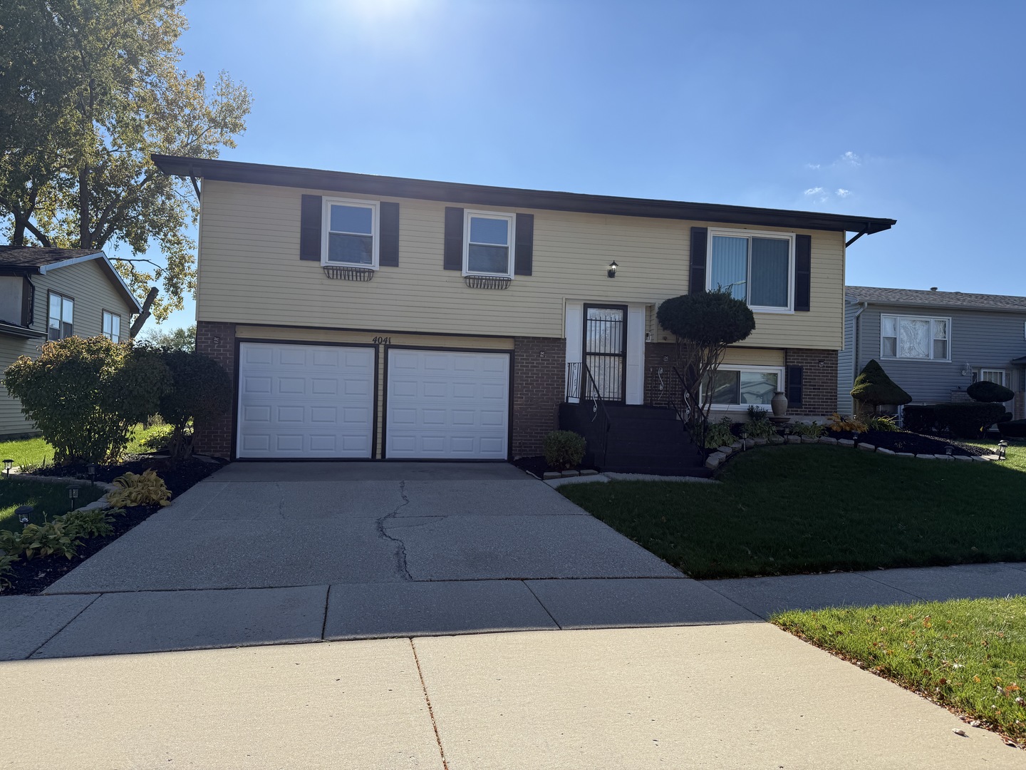a front view of a house with a garden