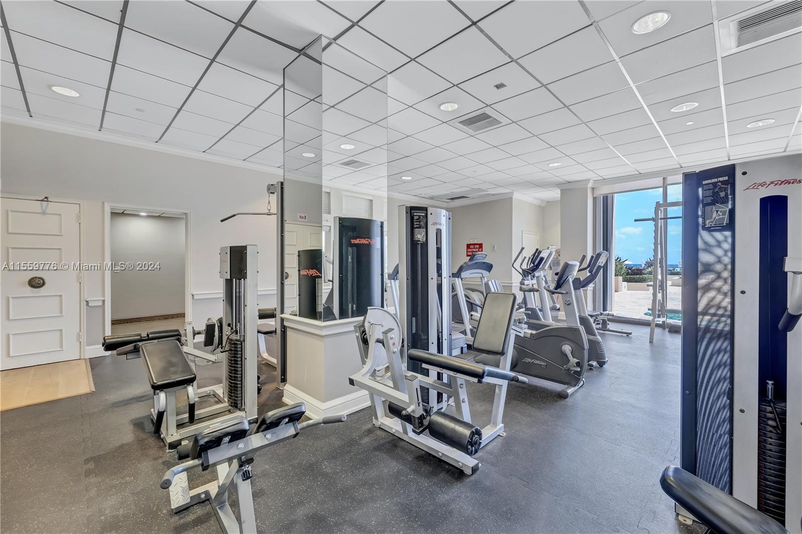 1900 South Ocean Boulevard, Unit 11B Lauderdale-by-the-Sea, FL 33062 - Photo 12 of 19 a view of a room with gym equipment
