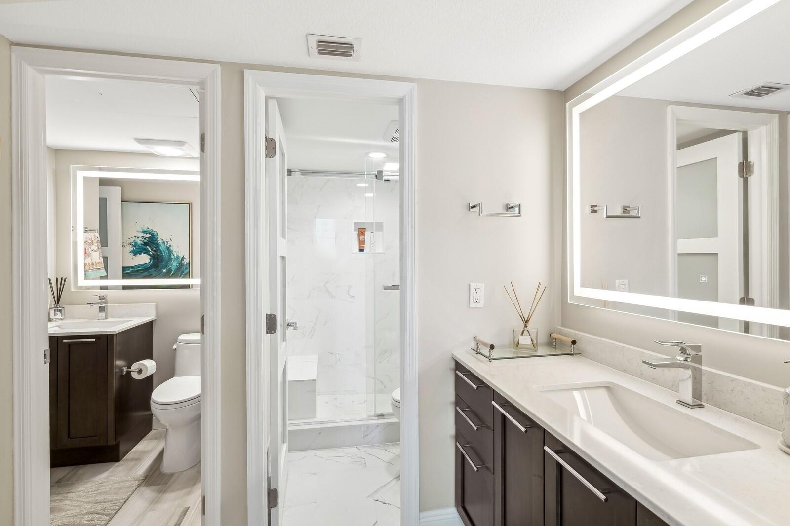 1900 South Ocean Boulevard, Unit 11B Lauderdale-by-the-Sea, FL 33062 - Photo 4 of 19 a bathroom with a granite countertop sink and a mirror