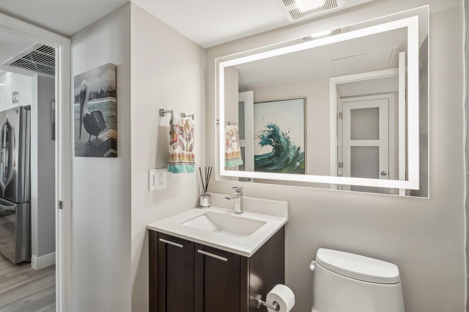 1900 South Ocean Boulevard, Unit 11B Lauderdale-by-the-Sea, FL 33062 - Photo 10 of 19 a bathroom with a sink a toilet and shower