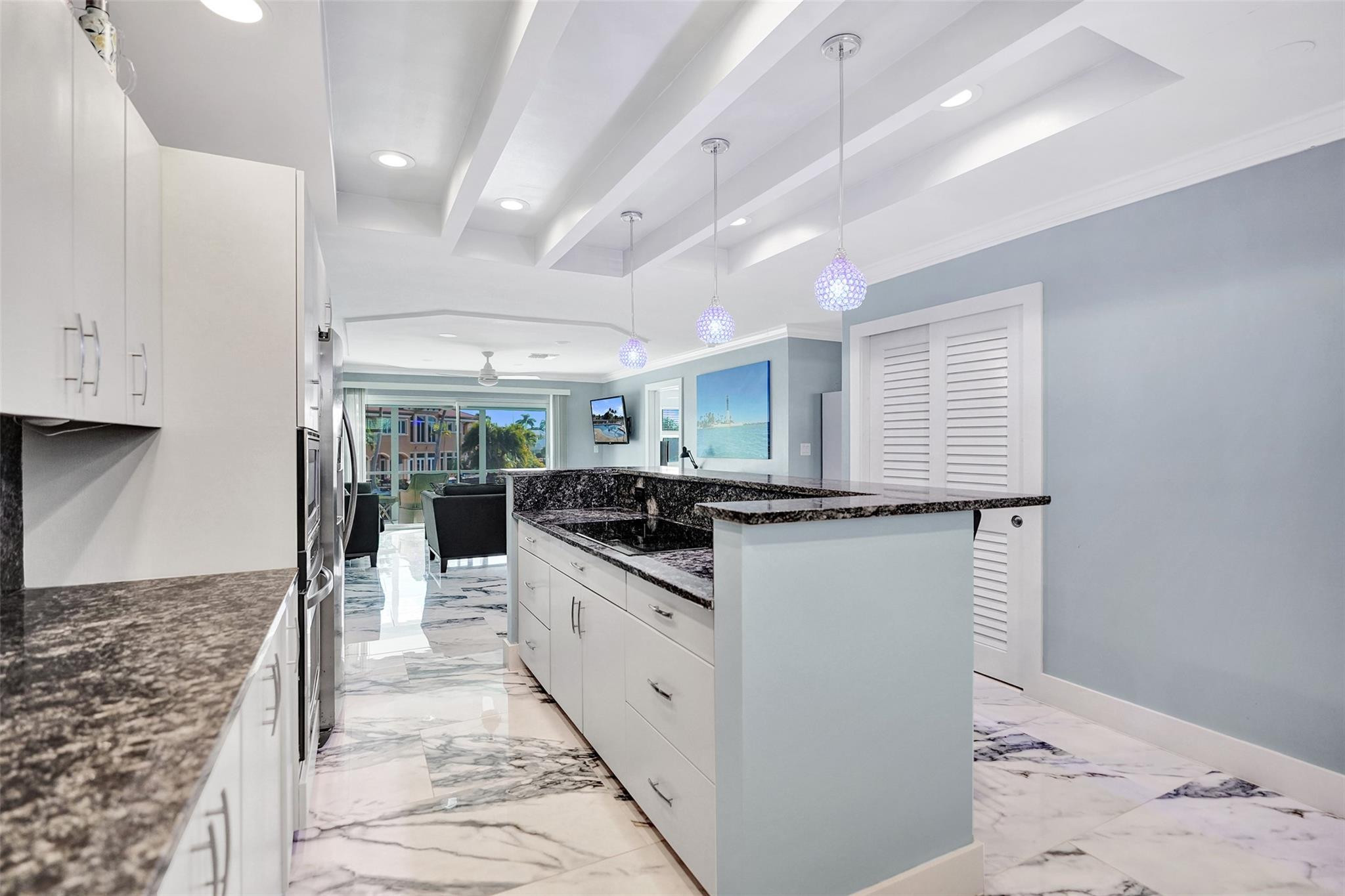 2330 Northeast 36th Street, Unit 9 Lighthouse Point, FL 33064 - Photo 13 of 48 a kitchen with stainless steel appliances granite countertop a stove a sink and a refrigerator
