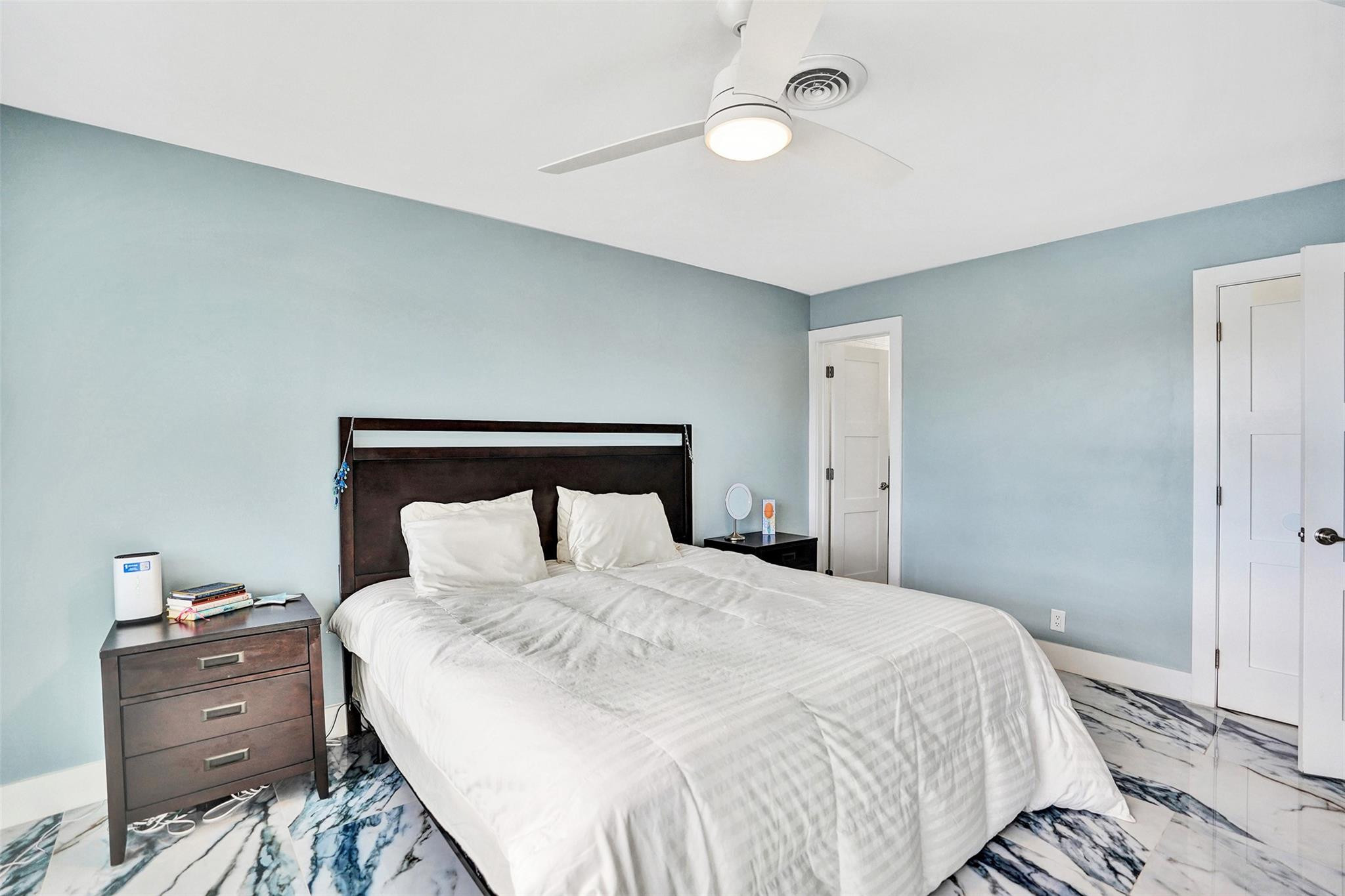 2330 Northeast 36th Street, Unit 9 Lighthouse Point, FL 33064 - Photo 30 of 48 a bedroom with a bed and a night stand