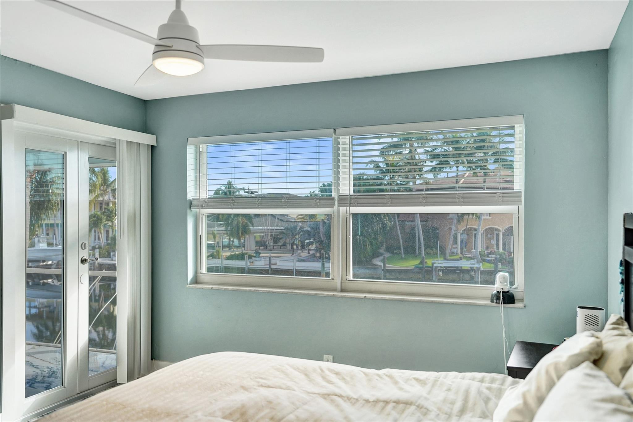 2330 Northeast 36th Street, Unit 9 Lighthouse Point, FL 33064 - Photo 32 of 48 a bedroom with a large bed and a window