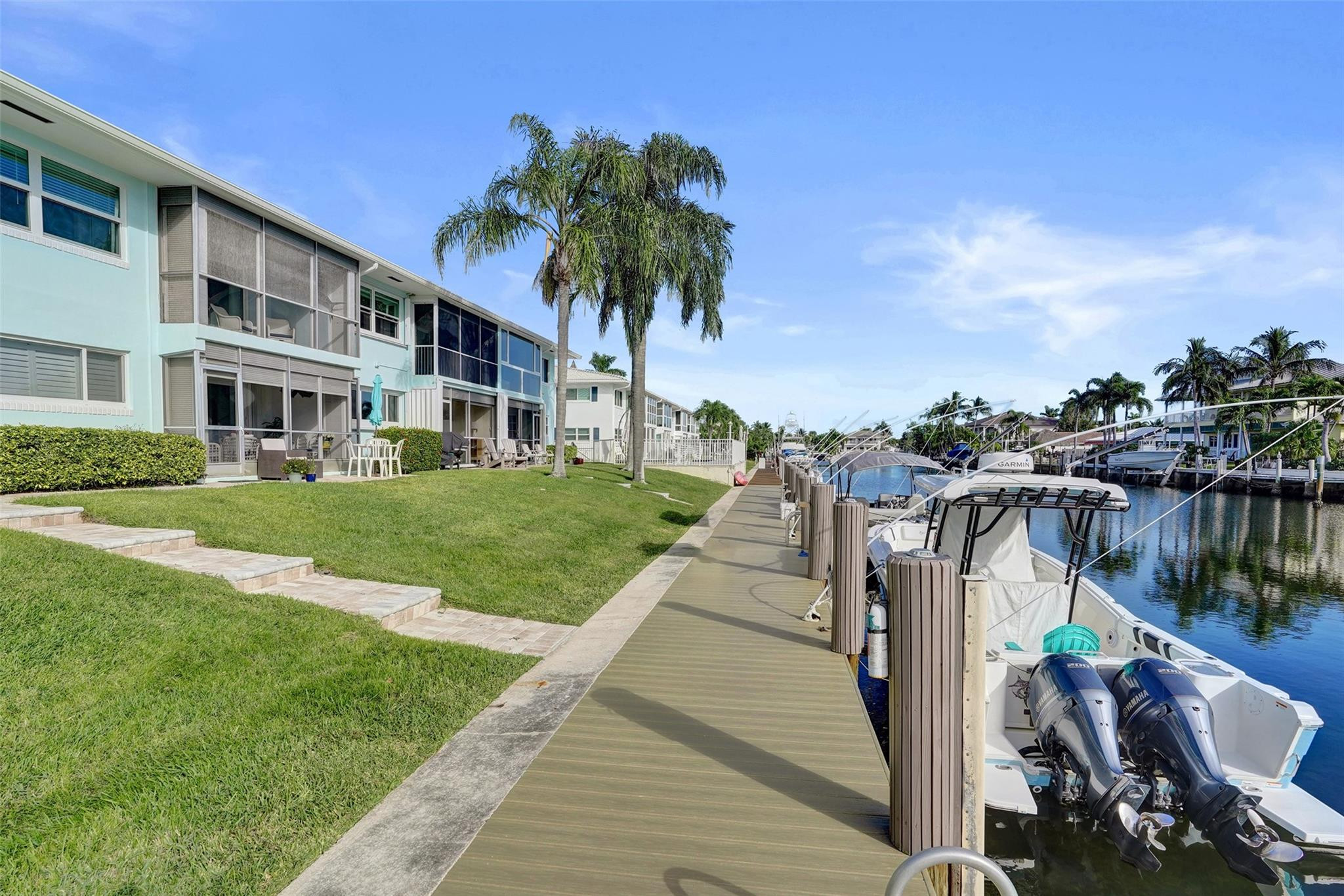 2330 Northeast 36th Street, Unit 9 Lighthouse Point, FL 33064 - Photo 45 of 48 a front view of multiple houses with yard