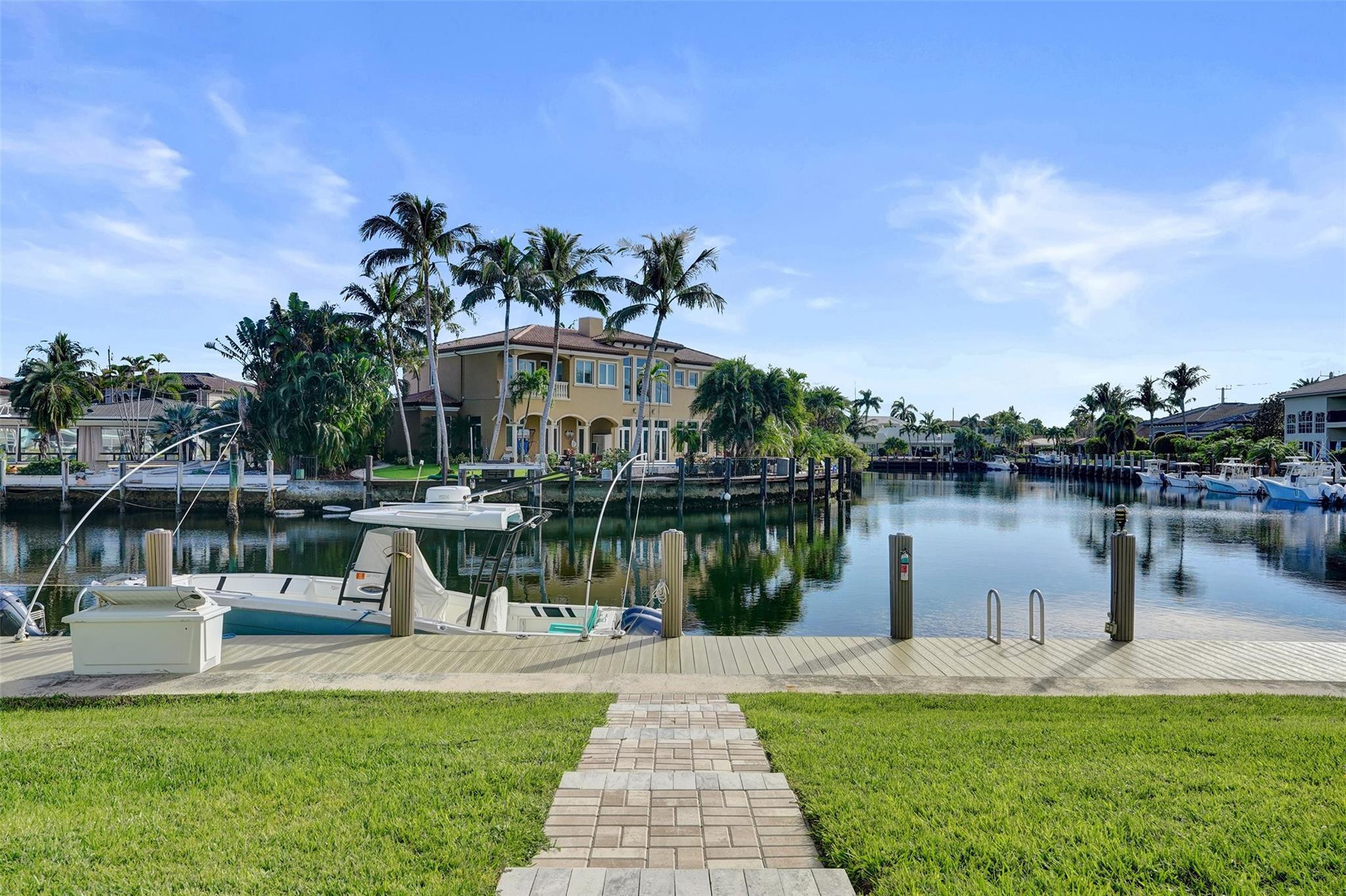 2330 Northeast 36th Street, Unit 9 Lighthouse Point, FL 33064 - Photo 47 of 48 a view of a lake with a water fountain and a big yard