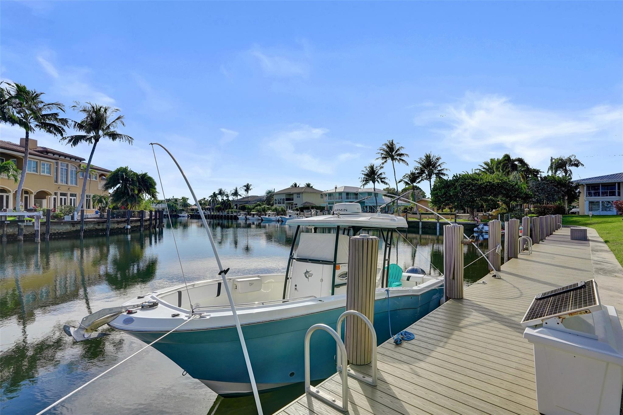 2330 Northeast 36th Street, Unit 9 Lighthouse Point, FL 33064 - Photo 9 of 48 a view of a lake with boats and trees in the background