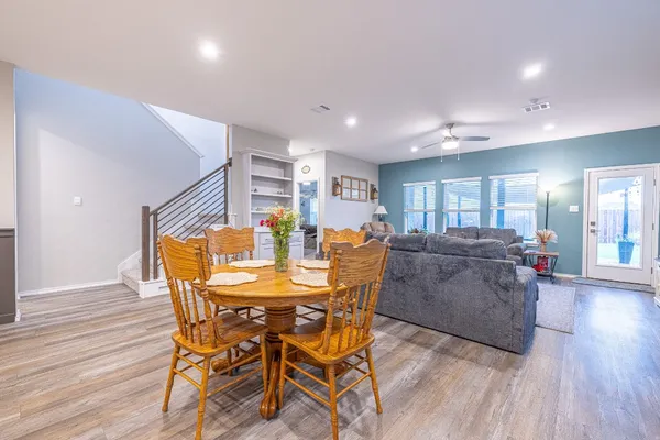 a view of a dining room with furniture and wooden floor