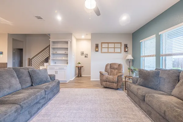 a living room with furniture and a large window