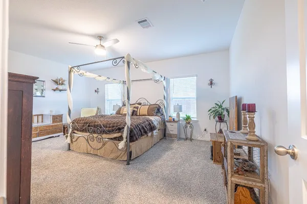 a bedroom with a bed and a chandelier