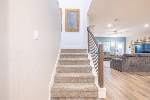 a view of entryway and hall with wooden floor